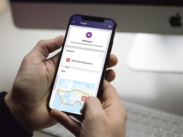 NOGGIN on iPhone X in Hand Mockup PSD